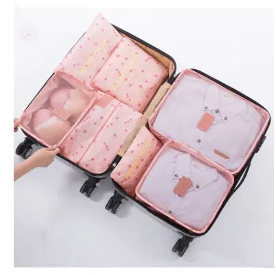 Set of six coloured nylon packing cubes and flat pouches for travel organisation.
