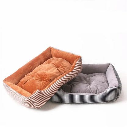 Oval cloth pet bed for dogs or cats in a striped colour pattern, showing its soft cushion shape.