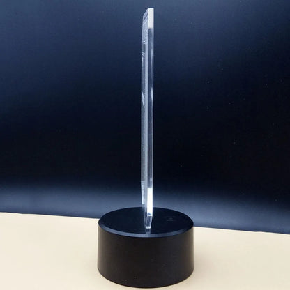 Brain-shaped 3D acrylic LED desk lamp on ABS base with remote control, showing colourful light projection.