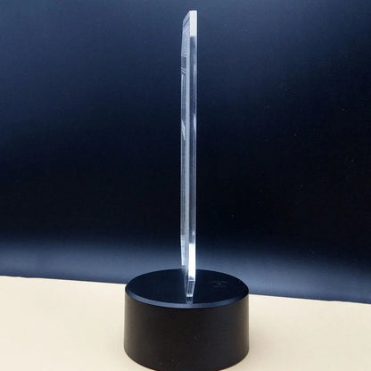 3D brain-shaped LED lamp with colour changing modes and remote control on wooden surface