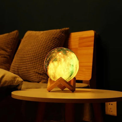 3D-printed spherical lunar night light with LED colours and remote control on a dark surface