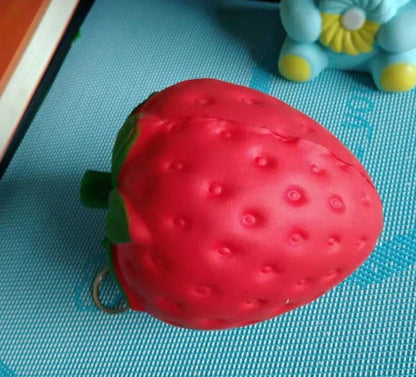 A squishy, strawberry-shaped stress relief ball made of durable polyurethane material