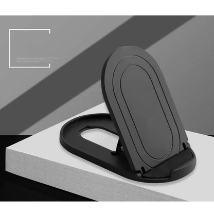 Black adjustable lazy bracket phone stand holding a mobile device at an angle on a wooden table.