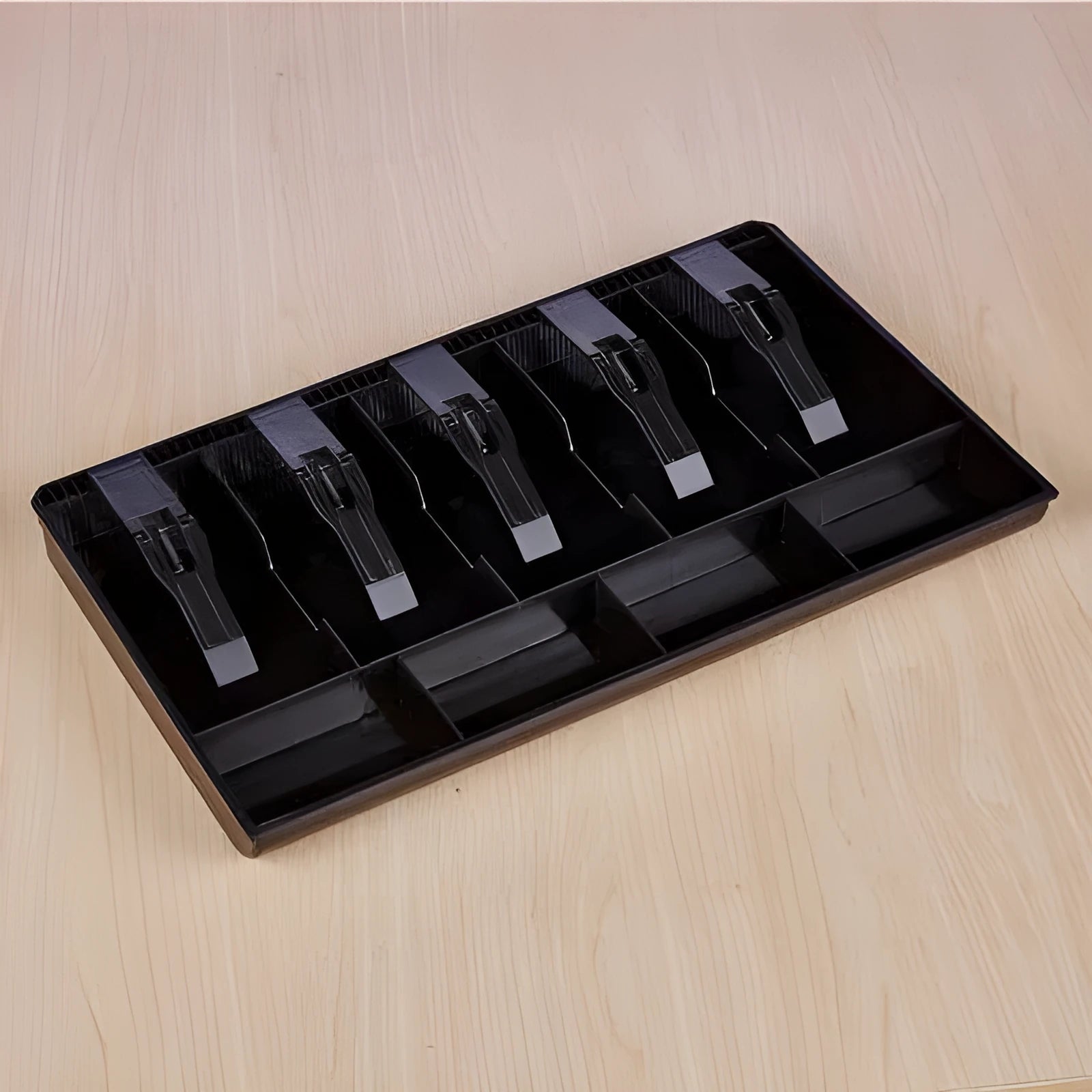 Black ABS plastic cash drawer box with a wallet design drawer for banknotes and coins.