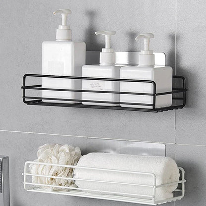 Black wrought iron bathroom shelf, 60cm long with drainage holes, holding shampoo bottles over tub edge
