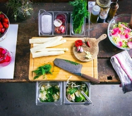 Bamboo cutting board with plastic storage trays for meal prep and organization