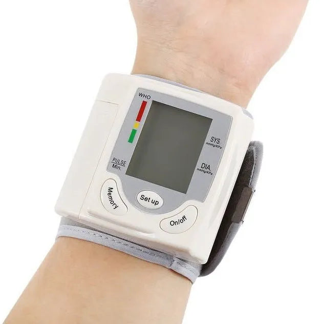 Grey wrist blood pressure monitor with compact design and digital display