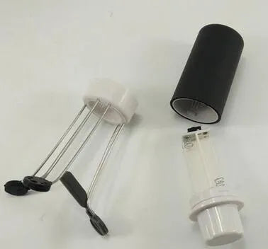 White and black wireless automatic kitchen stirrer with three-speed button, shown next to a saucepan.