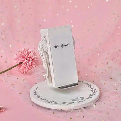 Angelic wireless charger with unfolding wings, providing fast charging and elegant design for smartphones