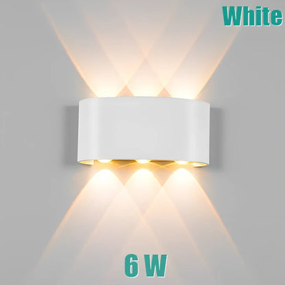 Waterproof black aluminium LED wall lamp 4W warm white emitting 60-degree beam angle mounted on white wall