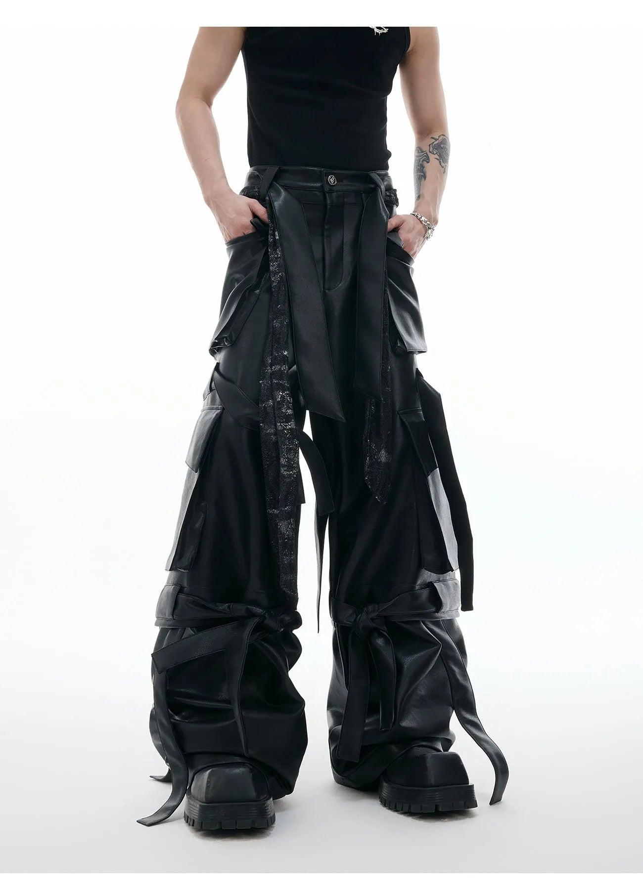Black loose-fit trousers with quilted texture, multiple pockets, and stitching ribbon leather accents on model