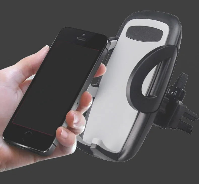 Black plastic mobile phone holder attached to a car air conditioning vent.