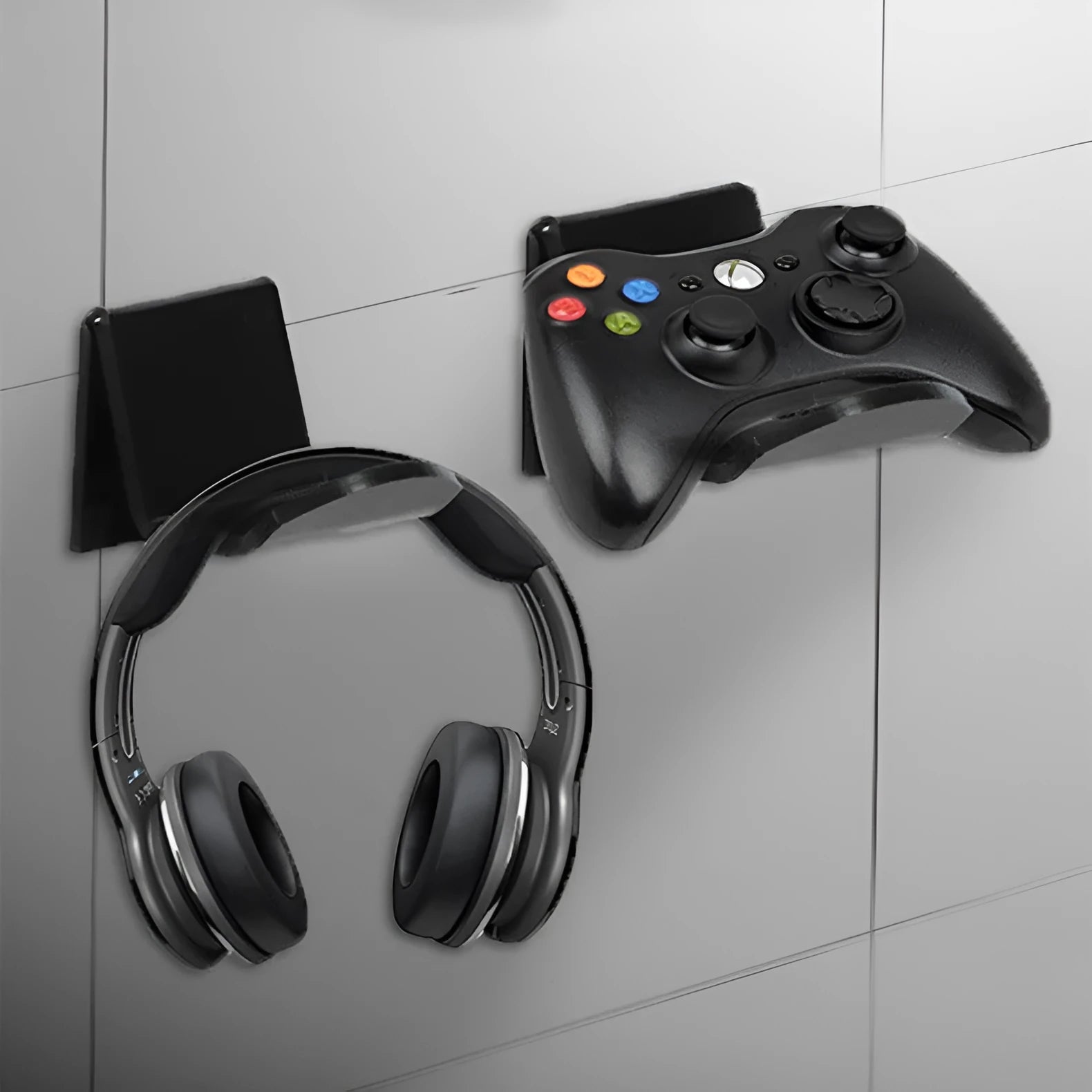 A universal black game controller mounting bracket shown installed on a wall.