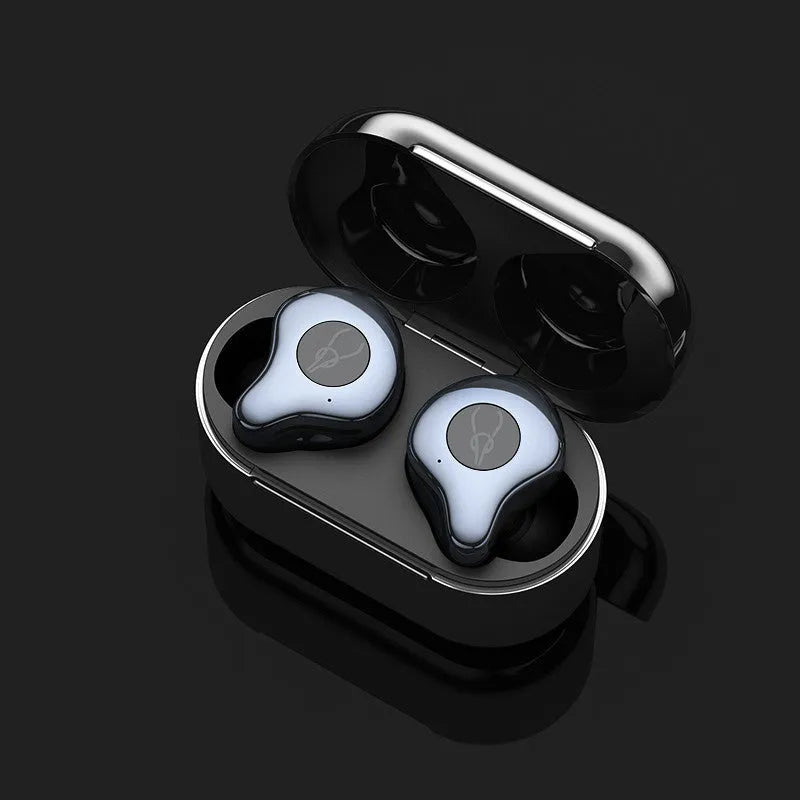 Coffee-coloured true wireless Bluetooth earbuds sitting in an open charging case on a wooden table.