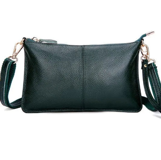 Lady's cowhide slant bag in apricot colour showing front view with strap and compact 24 cm size.