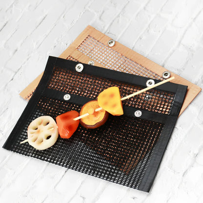 Black grill mesh bag with non-stick grid mat on barbecue, showing smoke circulation through mesh design