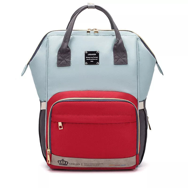 Mummy Maternity Bag in various colors, featuring a backpack design and zipper closure