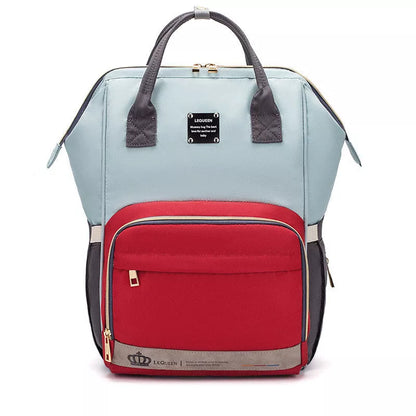 Mummy Maternity Bag in various colors, featuring a backpack design and zipper closure