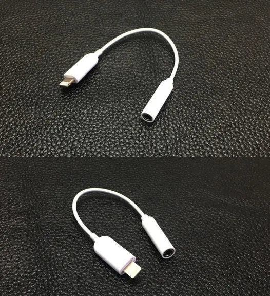 White Lightning to 3.5mm audio adapter cable for Apple iPhone on a dark background