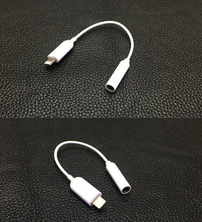 White Lightning to 3.5mm audio adapter cable for Apple iPhone on a dark background
