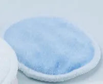 Set of water pink and light blue velvet makeup remover pads next to a cotton mesh storage bag.