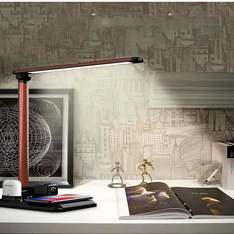 Black and white 4-in-1 LED desk lamp with wireless charging pad and Bluetooth speaker