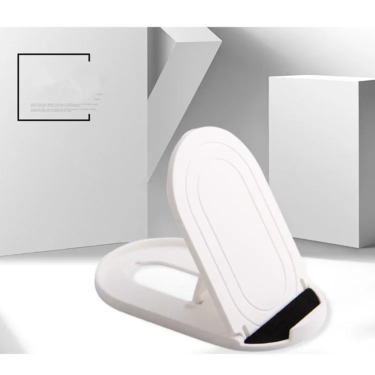 Black adjustable lazy bracket phone stand holding a mobile device at an angle on a wooden table.