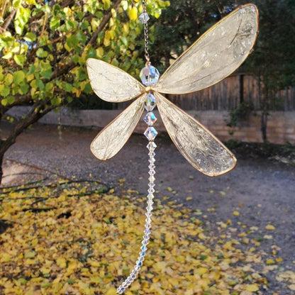 Radiant dragonfly crystal suncatcher with vibrant rainbow colors reflecting on walls and floors