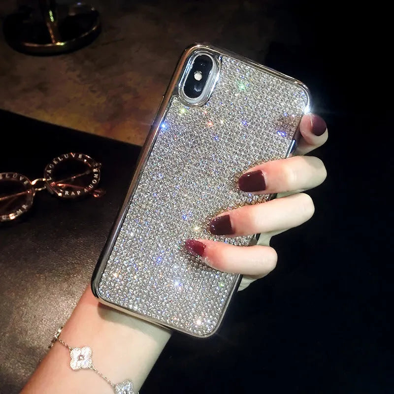 Silver silicone phone case with sparkling diamond decoration for various iPhone models.