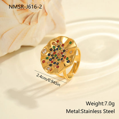 Pleated geometric open mouth ring made from stainless steel with colourful crystal inlay on a hand.