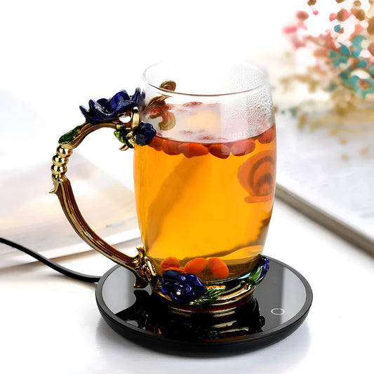 Black coffee mug warmer pad with temperature switch on desk