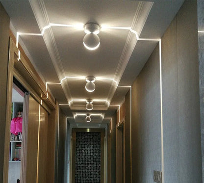 Aluminium and glass LED wall spotlight bar with colour change options, mounted on a corridor wall.