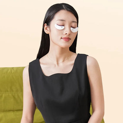 BIO9 eye massager with red light and EMS pulse modes, shown with included gel eye masks