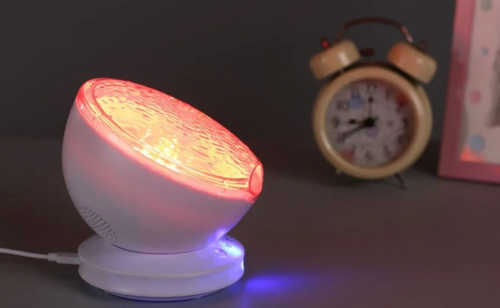 White and blue ocean wave projector measuring 13x12x12 cm with remote control