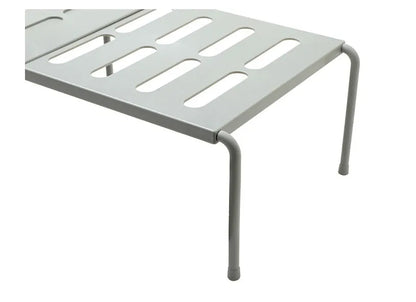 White telescopic kitchen storage rack at adjustable height on a countertop