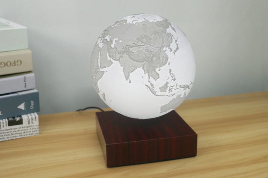 Levitating Earth or Jupiter lamp floating above base with LED illumination