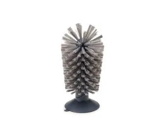 Grey rotating double-head cup brush with suction cups for wall mounting.