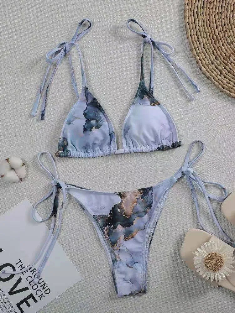 Women's high-waist bikini set with U-neck top in a blue marble tie-dye print.
