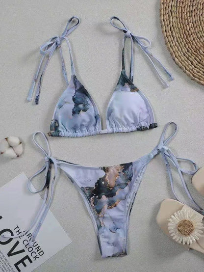 Women's high-waist bikini set with U-neck top in a blue marble tie-dye print.