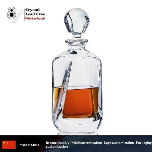 Hand-cut Bohemian crystal whiskey decanter with retro design and tapered pouring neck on wooden bar