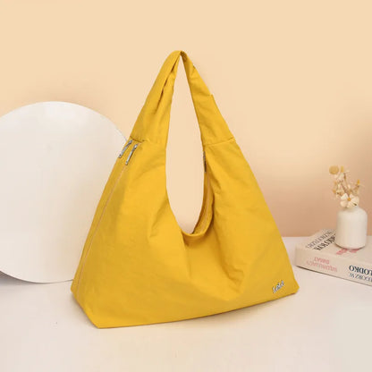 Heart-shaped soft nylon underarm shoulder bag for women in black, blue, khaki, or yellow.