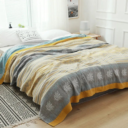 Pure cotton five-layer gauze bedspread blanket in Roulette Wheel Blue pattern on a bed.
