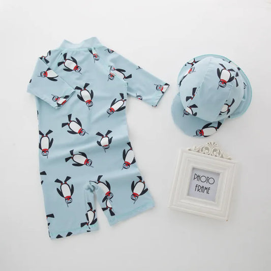 Boy's penguin print long sleeve swimsuit with matching cap for sun protection during water activities