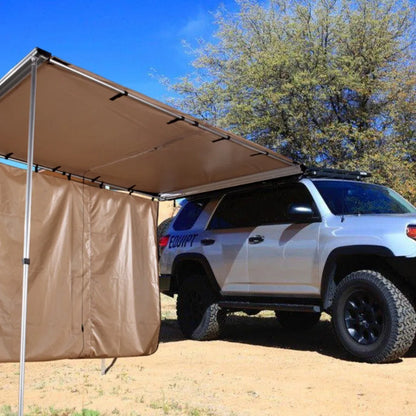 Black glue coated car sunshade tent with aluminium poles set up outdoors.
