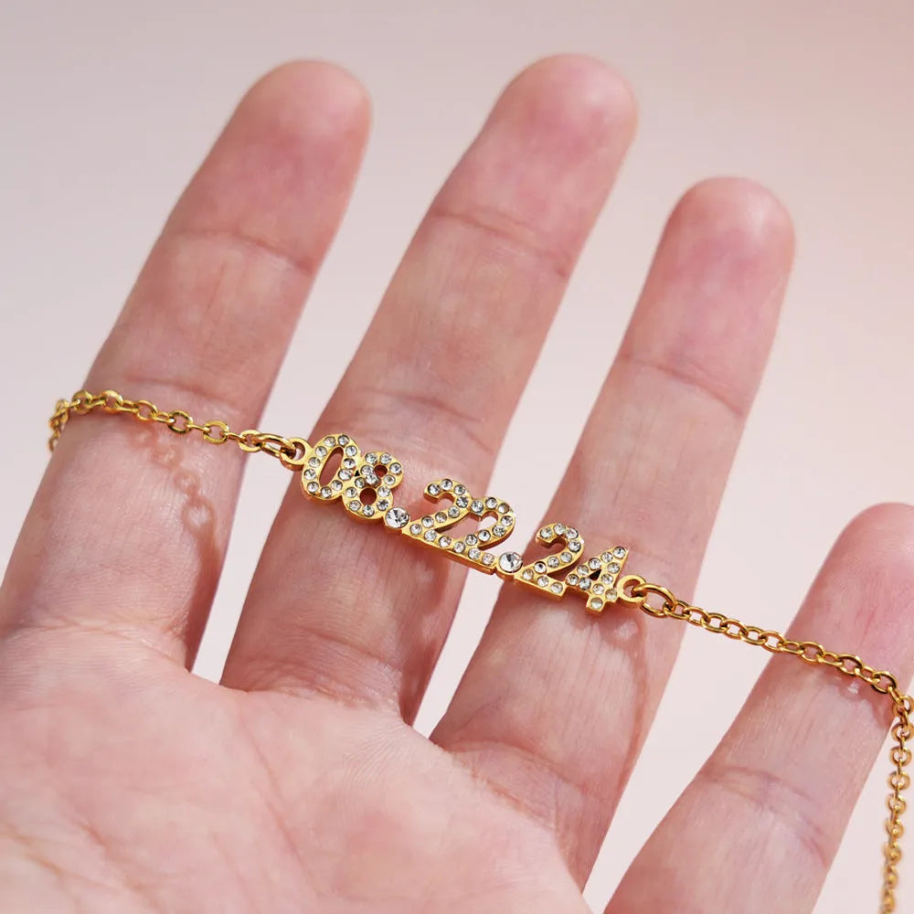 Stainless steel digital bracelet with diamond-set numbers showing time display in gold finish