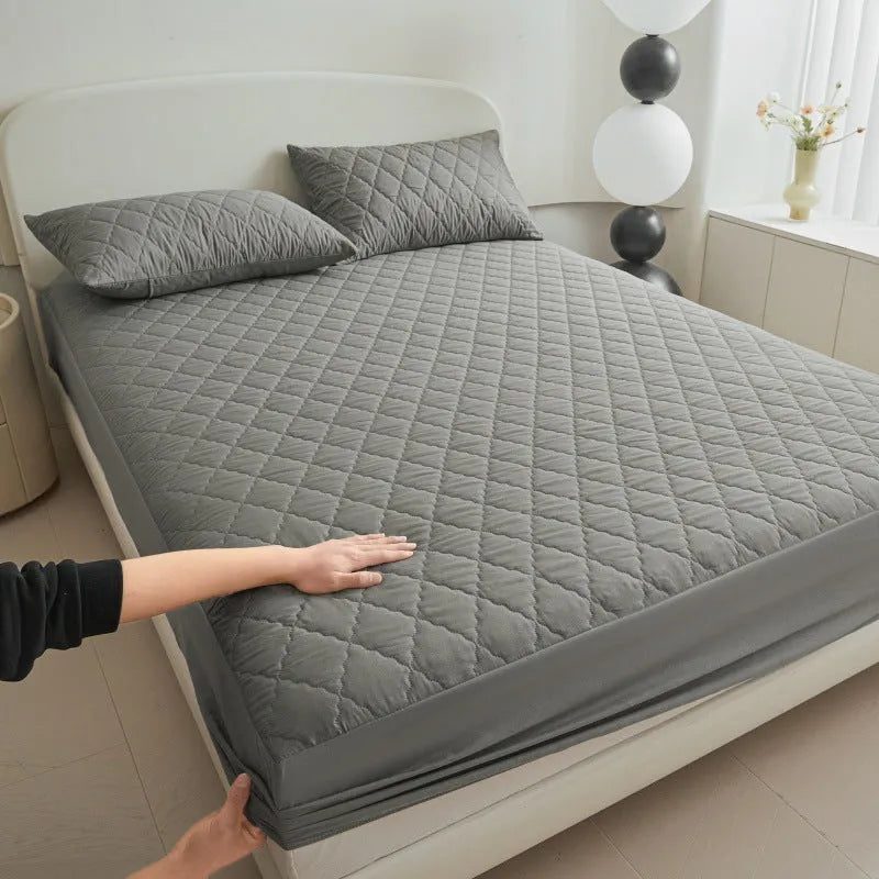 Diamond lattice quilted bamboo fibre mattress protector set in solid colour on a bed.