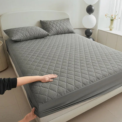 Diamond lattice quilted bamboo fibre mattress protector set in solid colour on a bed.
