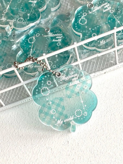 Blue, green, and mint green four-leaf clover acrylic pendant keychain on a metal ring.