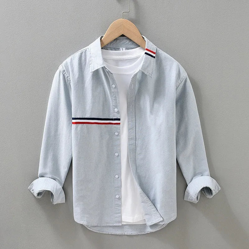 Hong Kong style loose cotton blend cardigan shirt in light blue on a hanger