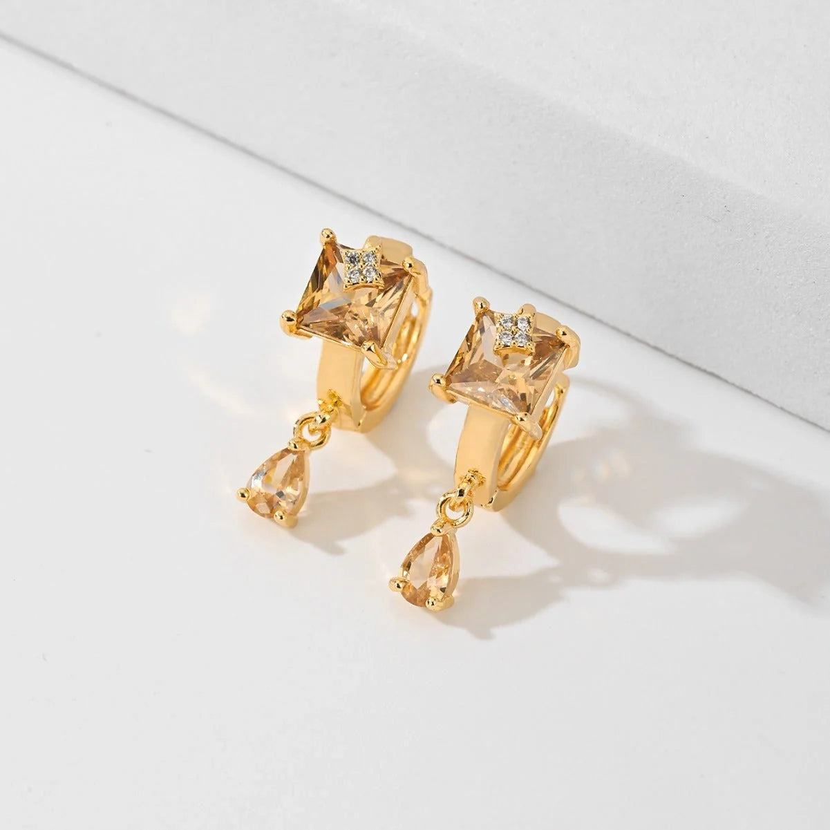Trendy copper-plated gold fashion earrings with water droplet design in multiple colors.